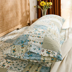 Side close-up of the cotton body pillowcase, highlighting the envelope closure and blue floral patchwork pattern detail.