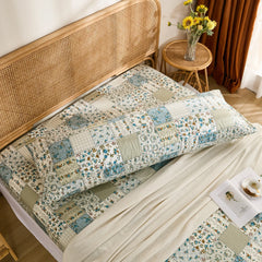High-angle overhead shot of the long cotton body pillowcase and matching patchwork fitted sheet set.
