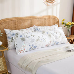 The long cotton body pillowcase styled on the bed with other pillows, showcasing a layered bedding look.