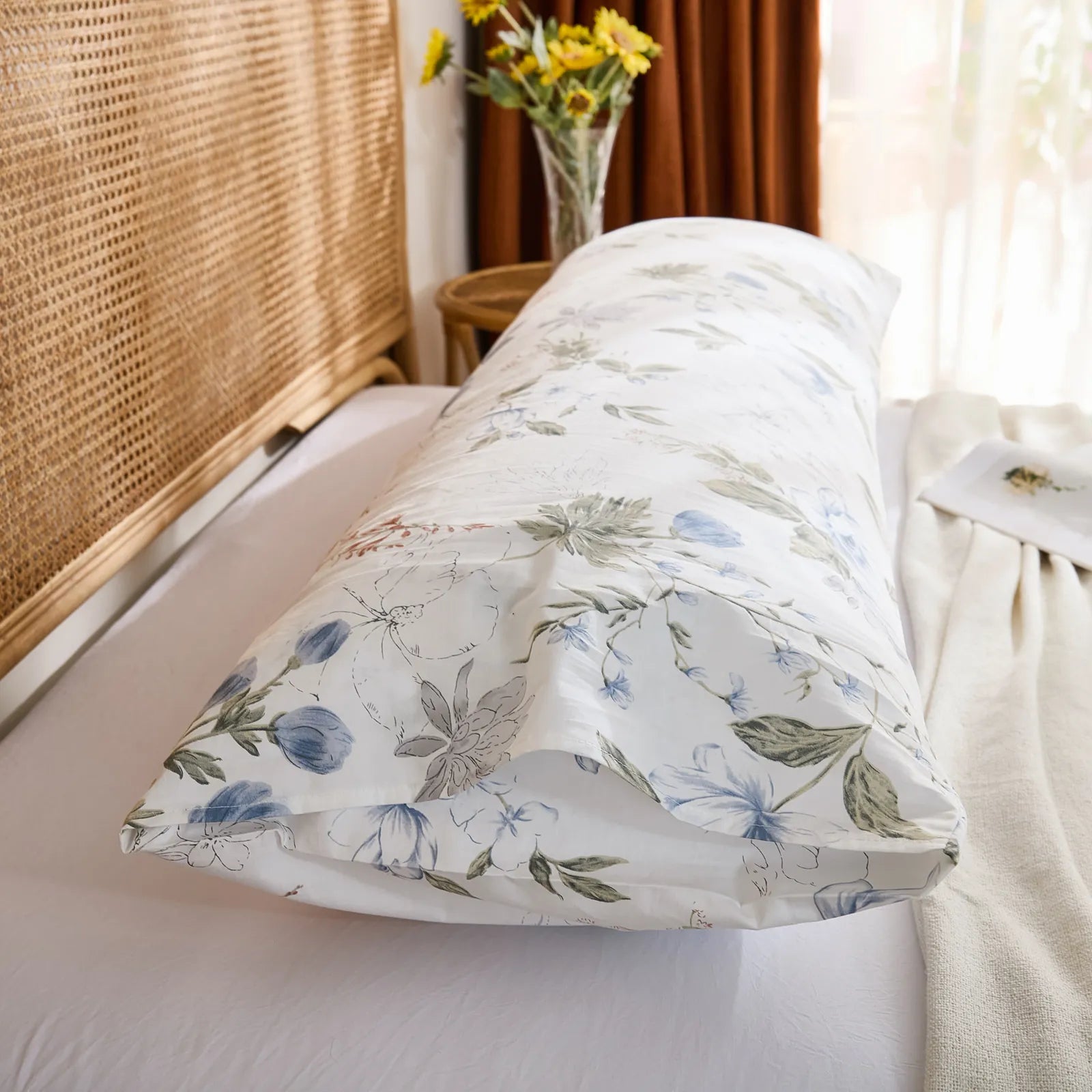 Side close-up of the cotton body pillowcase, highlighting the envelope closure and the soft blue floral pattern.