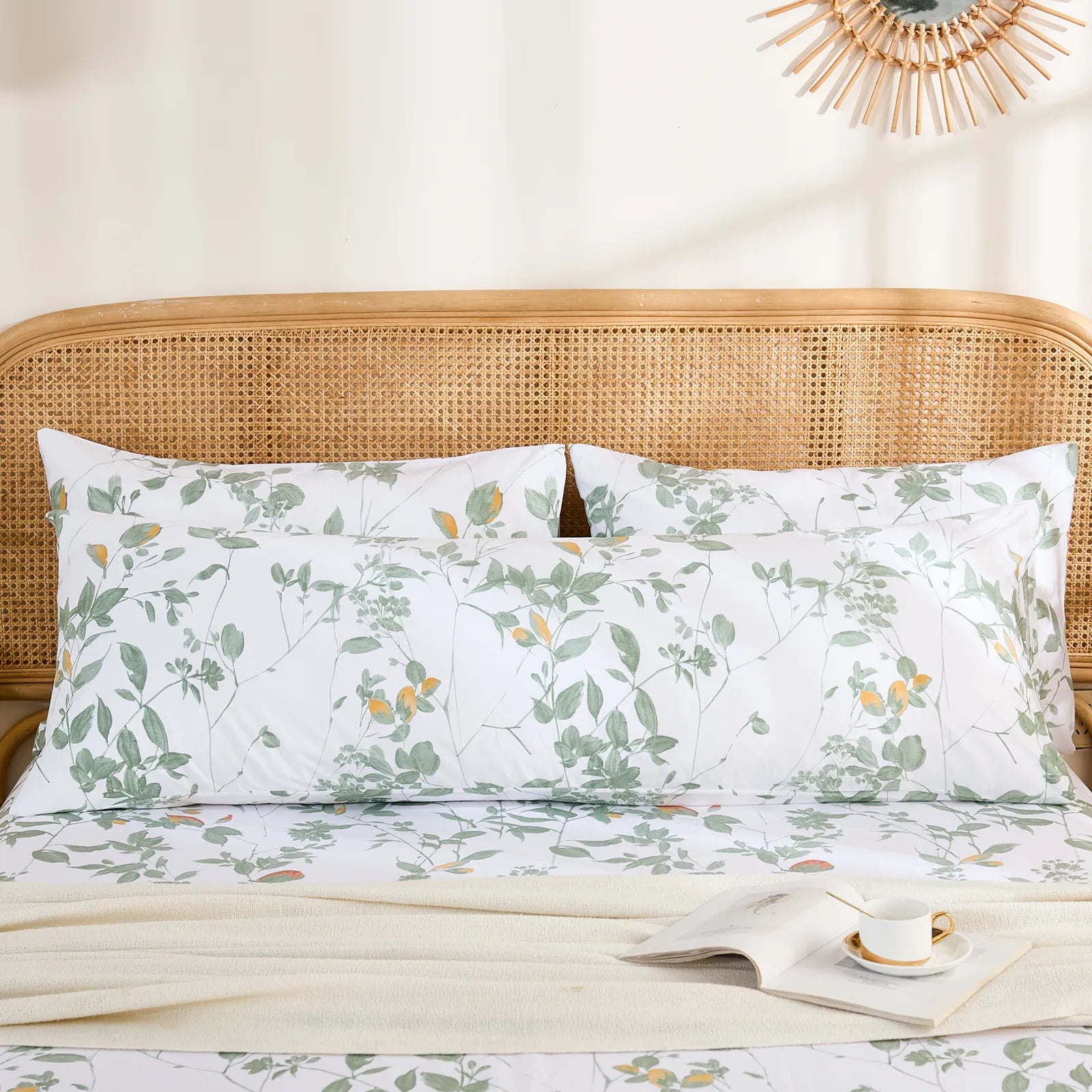 The long cotton green leaf body pillowcase positioned horizontally behind two standard pillows for layered bedding.