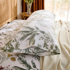 Side close-up of the cotton body pillowcase, showing the envelope closure detail and the dark green tropical leaf pattern.