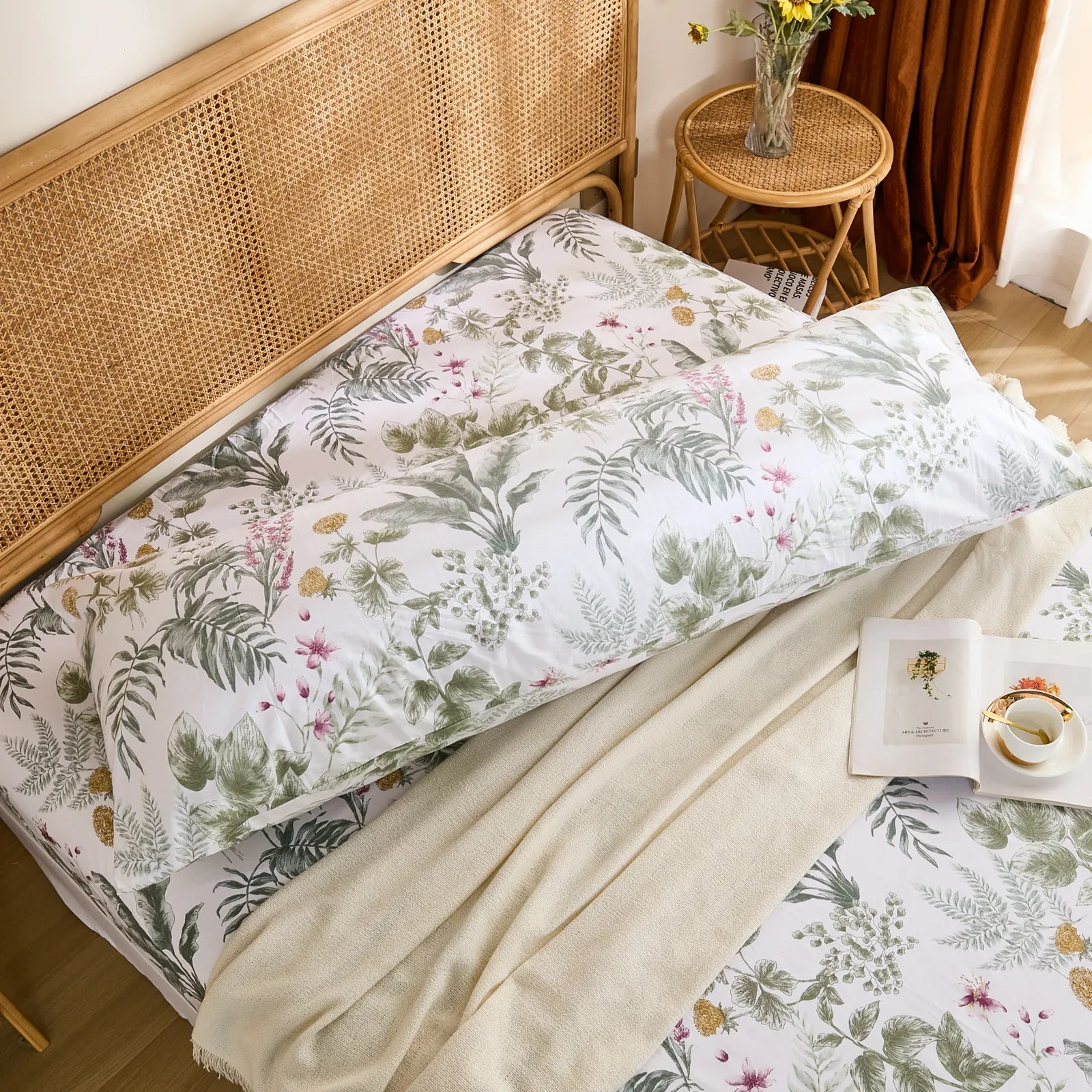 Overhead shot of the long cotton tropical body pillowcase, resting diagonally across the bed for a top-down view.