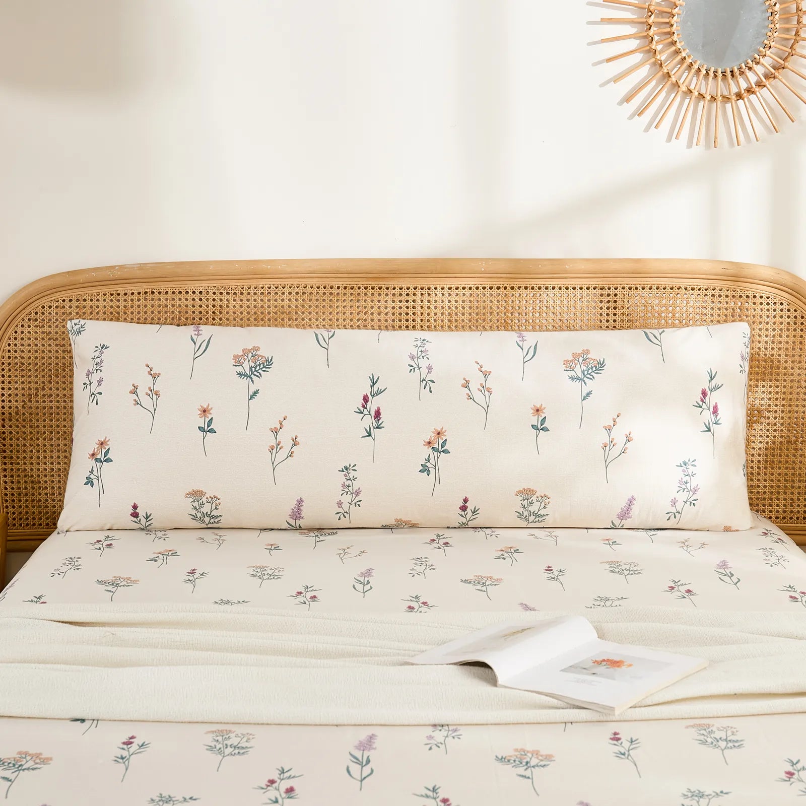 Full front view of a long cotton body pillowcase with a bohemian wildflower print, displayed on a bed.