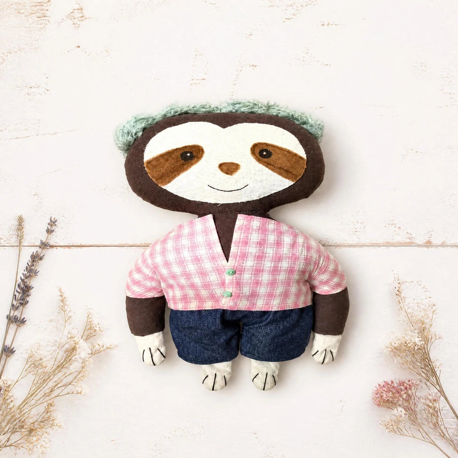 artisan crafted sloth cloth doll flat lay white wood