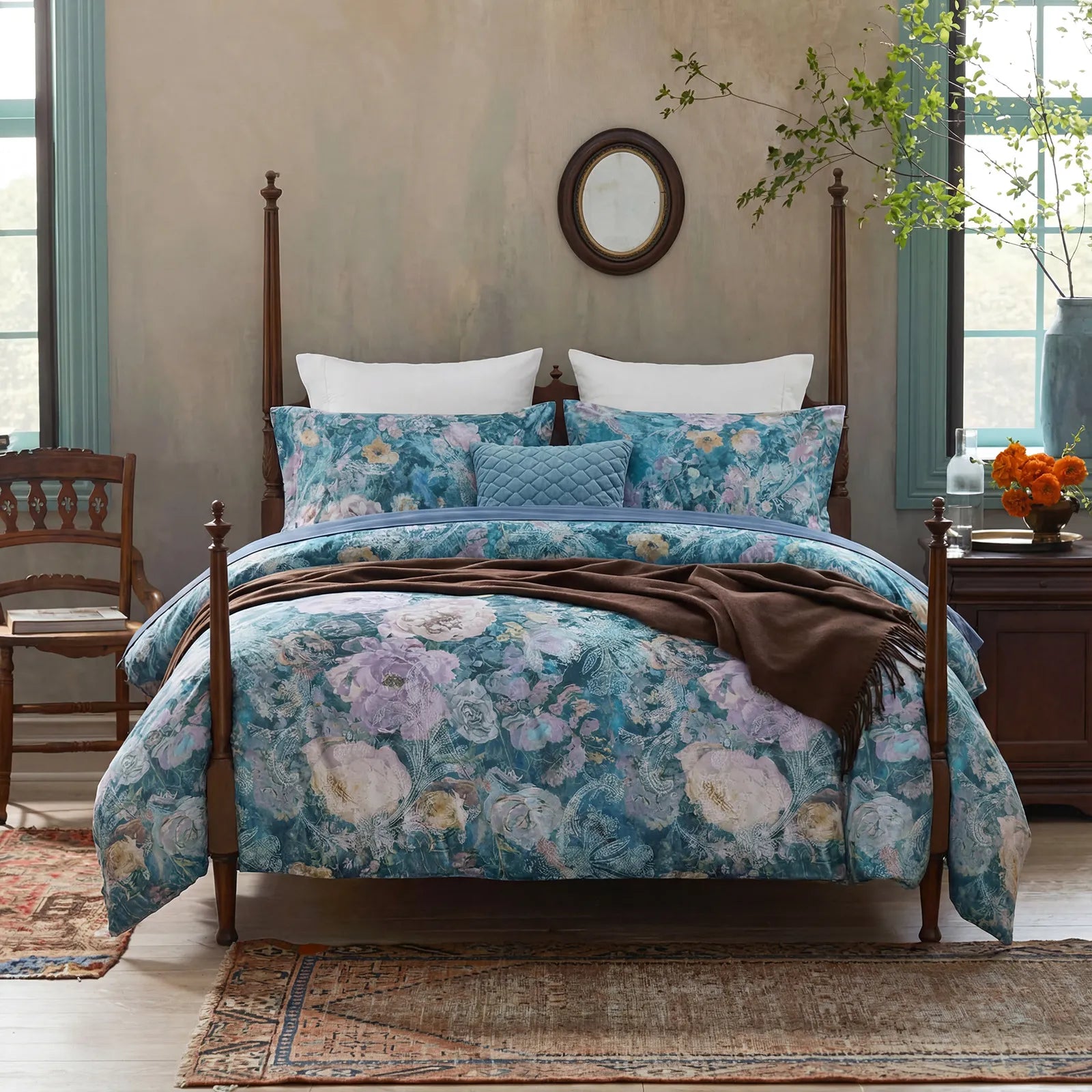 Front view of artistic floral bedding in a rustic bedroom
