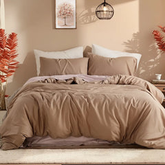 Front symmetrical view of beige camel solid duvet cover on bed with balanced nightstands and hanging lamp.