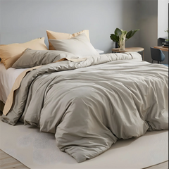 Angled view of beige grey duvet cover showing pillows and fabric texture