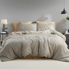 Beige Grey duvet cover front view with four pillows on bed