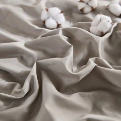 Close-up texture detail of beige grey duvet fabric with cotton accents