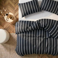 Overhead flat lay of black striped duvet and cases