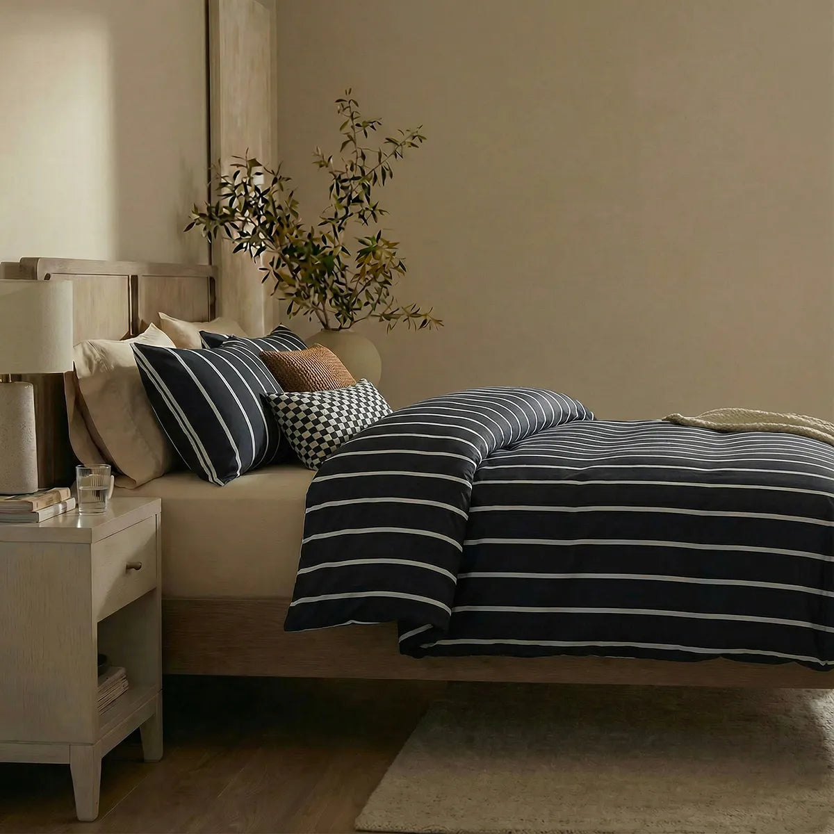Side view of black striped duvet and pillows
