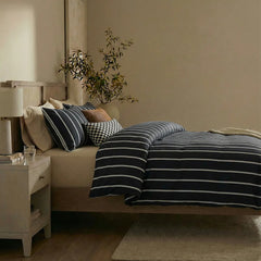 Side view of black striped duvet and pillows