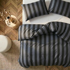Overhead flat lay of black and grey striped duvet and cases