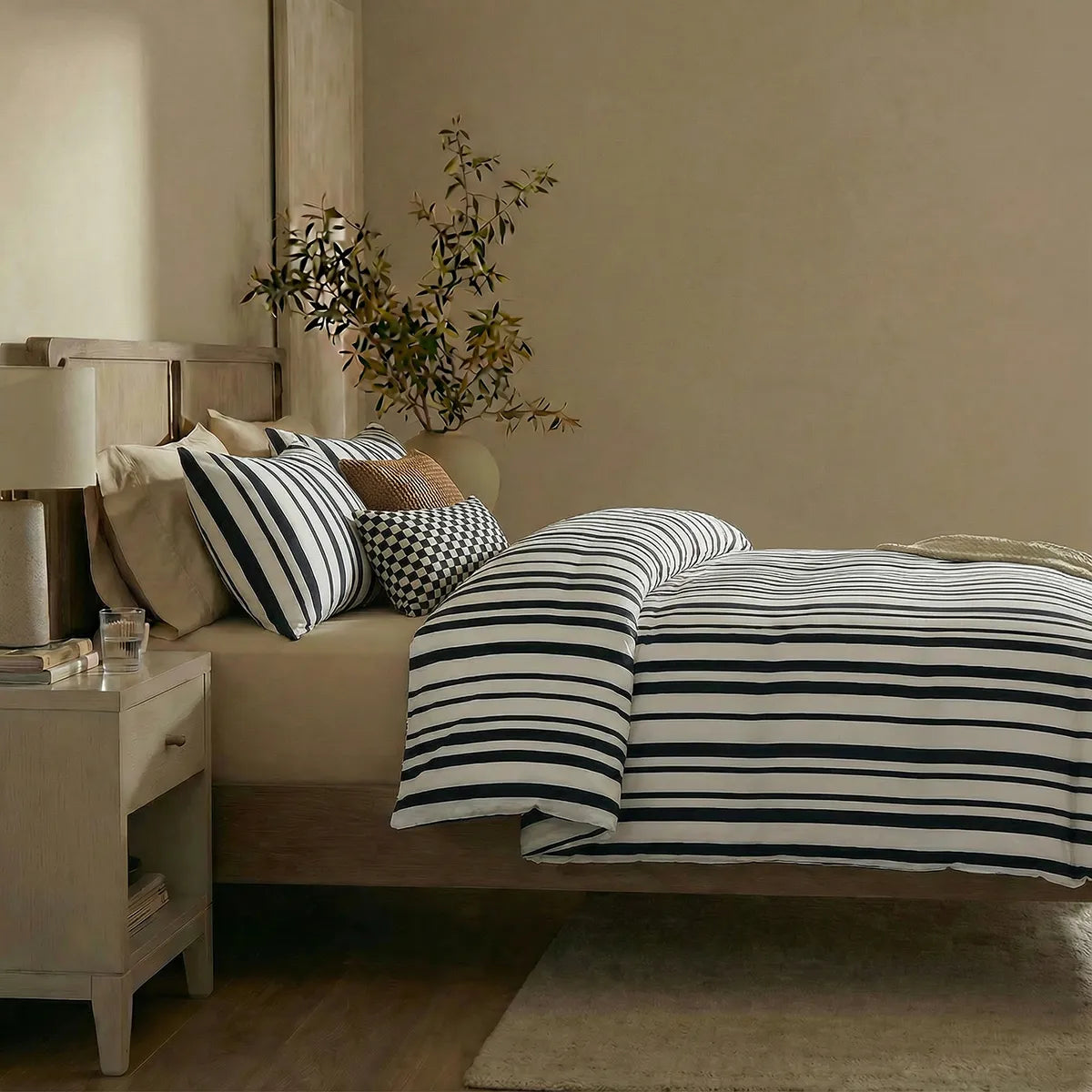 Side view of black and white striped duvet and pillows