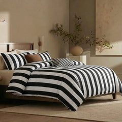 Angled shot of black white striped duvet cover on bed