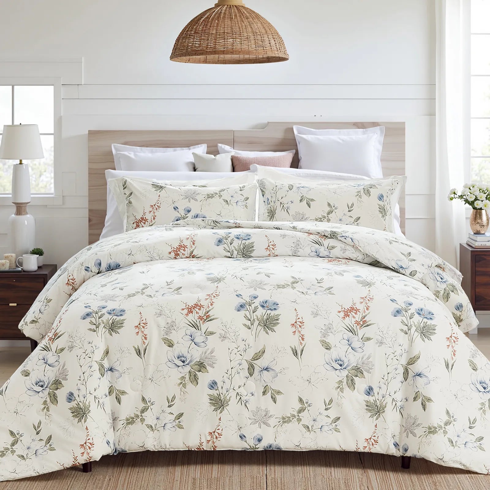 Bed with white floral comforter and pillows in a rustic bedroom with wood headboard and nightstand.