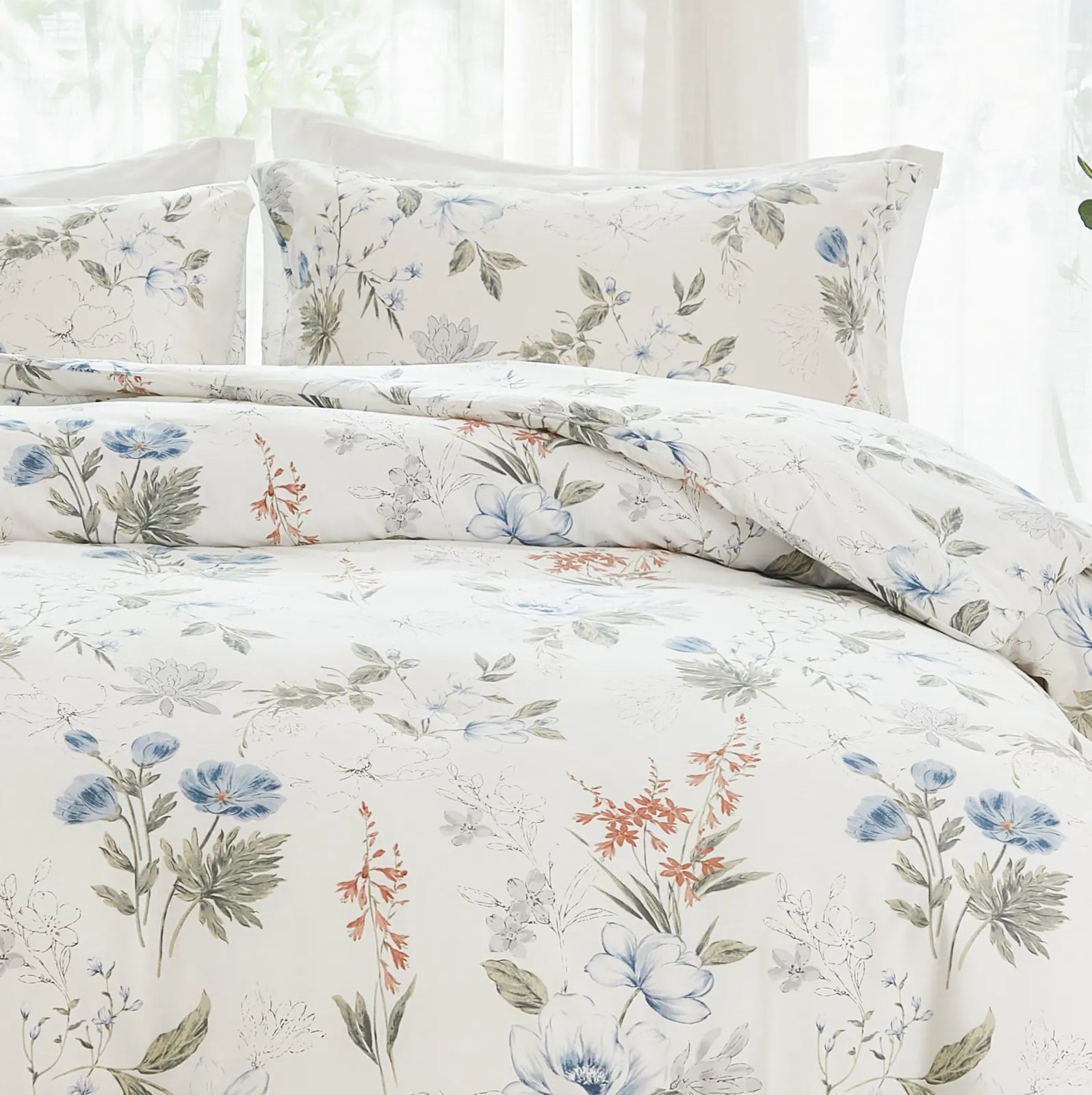 View of the blue floral pillows and a corner of the duvet cover