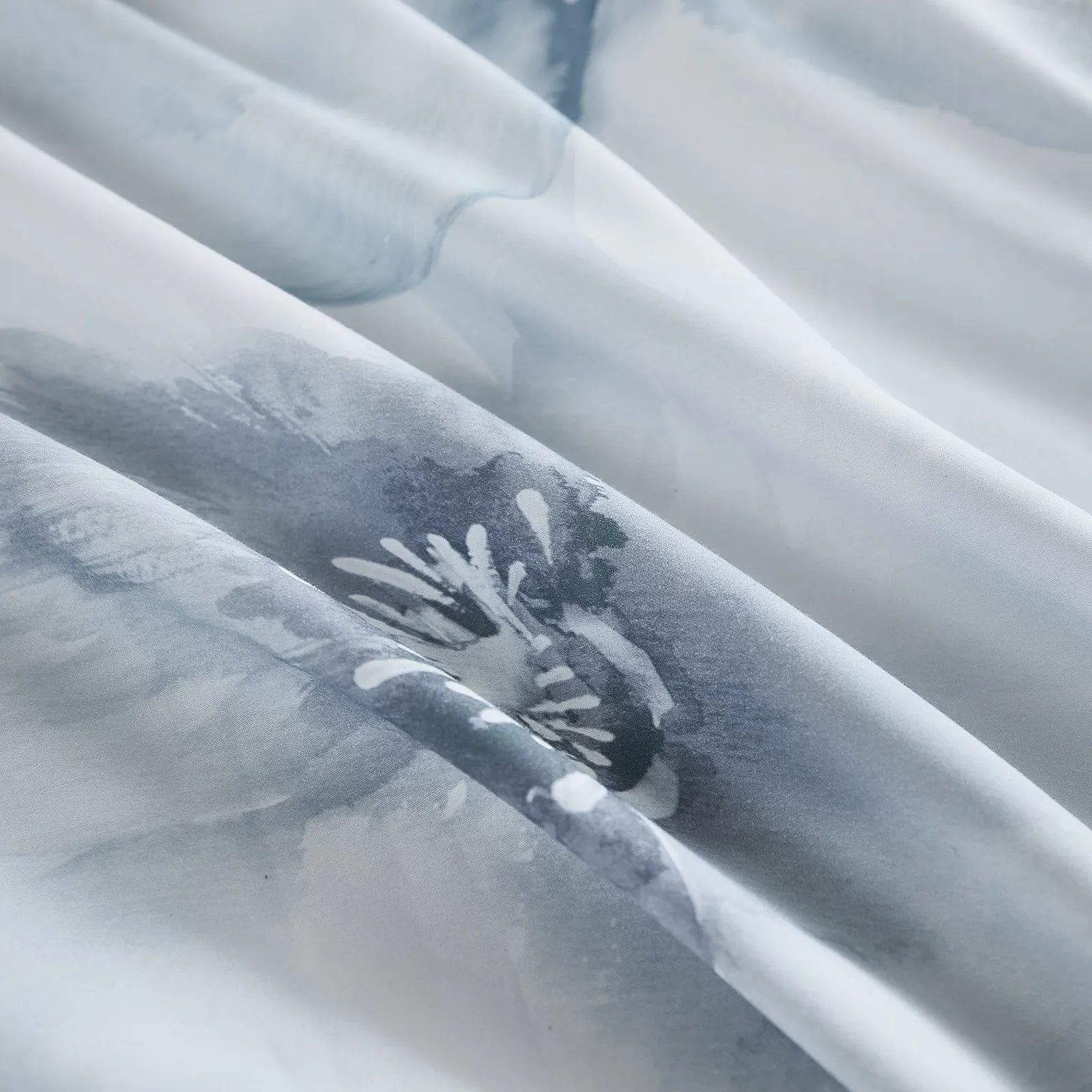 Close up of blue watercolor floral bedding fabric