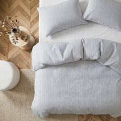 Overhead flat lay of blue white striped duvet and cases