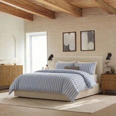 Angled shot of blue white grey striped duvet cover on bed