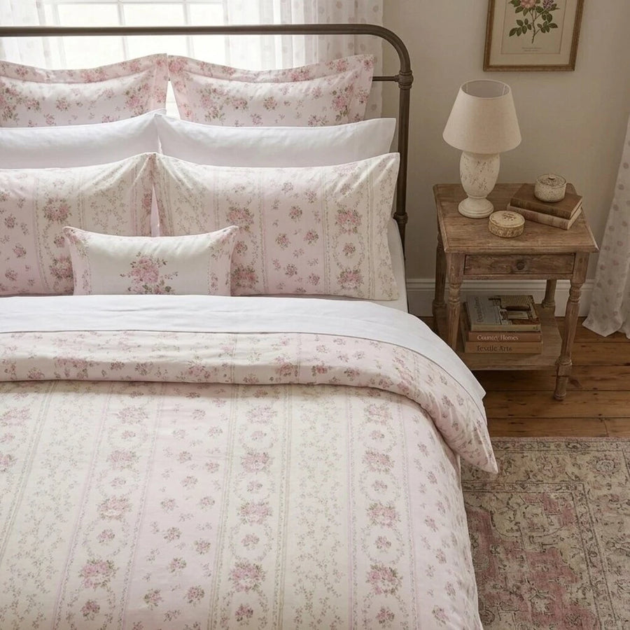 romantic rose floral striped duvet cover set styled on bed with iron headboard side view