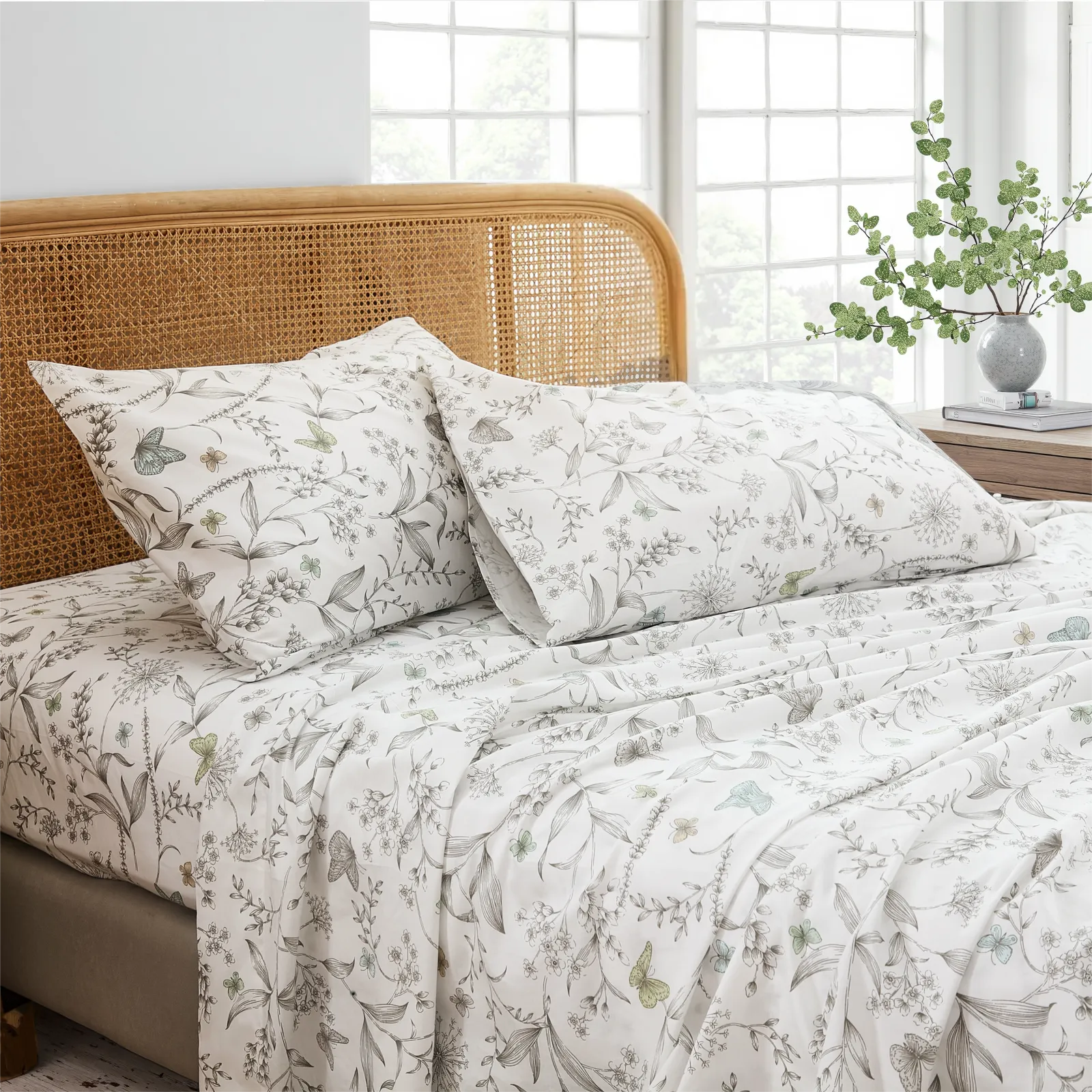 Close up detail of cotton botanical butterfly print pillows and fitted sheet set