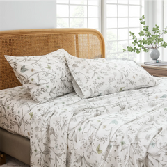 Close up detail of cotton botanical butterfly print pillows and fitted sheet set