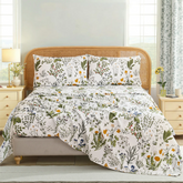 Styled shot of Lush Botanical cotton bedding set on bed with rattan headboard