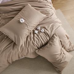Top view layout of brown duvet with cotton accents