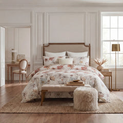 Floral pattern comforter on a bed in a room with white wall molding