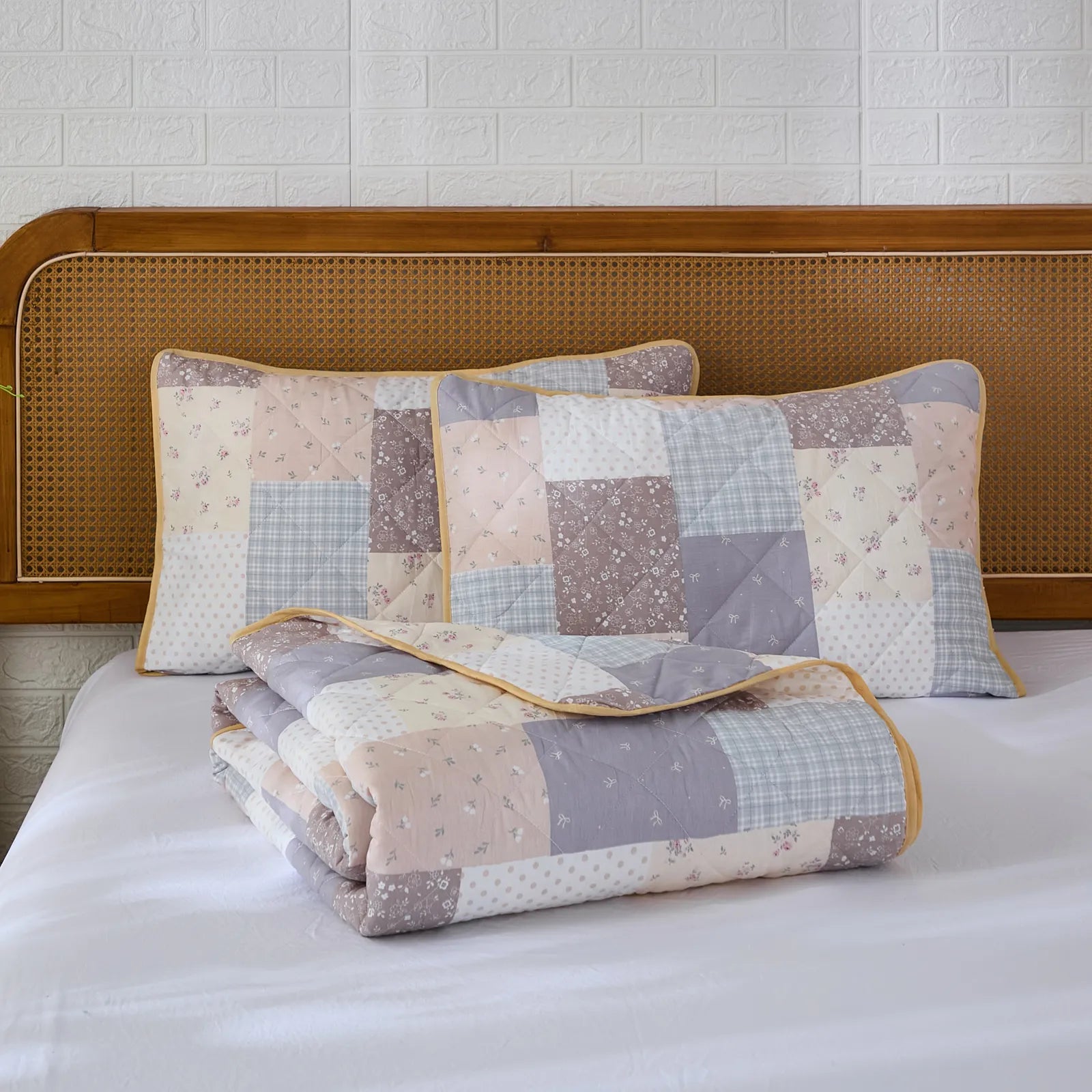 The cottage cotton floral quilt set folded neatly for display.