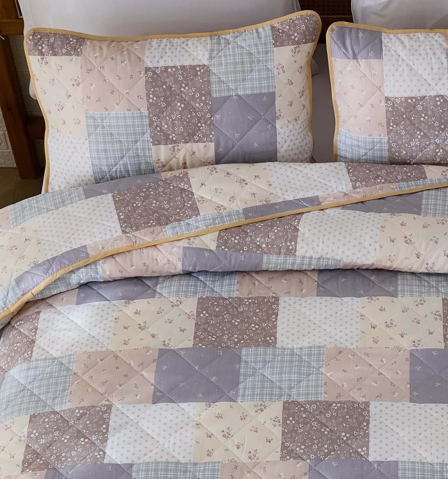 A detailed shot of the matching pillows and the quilted design