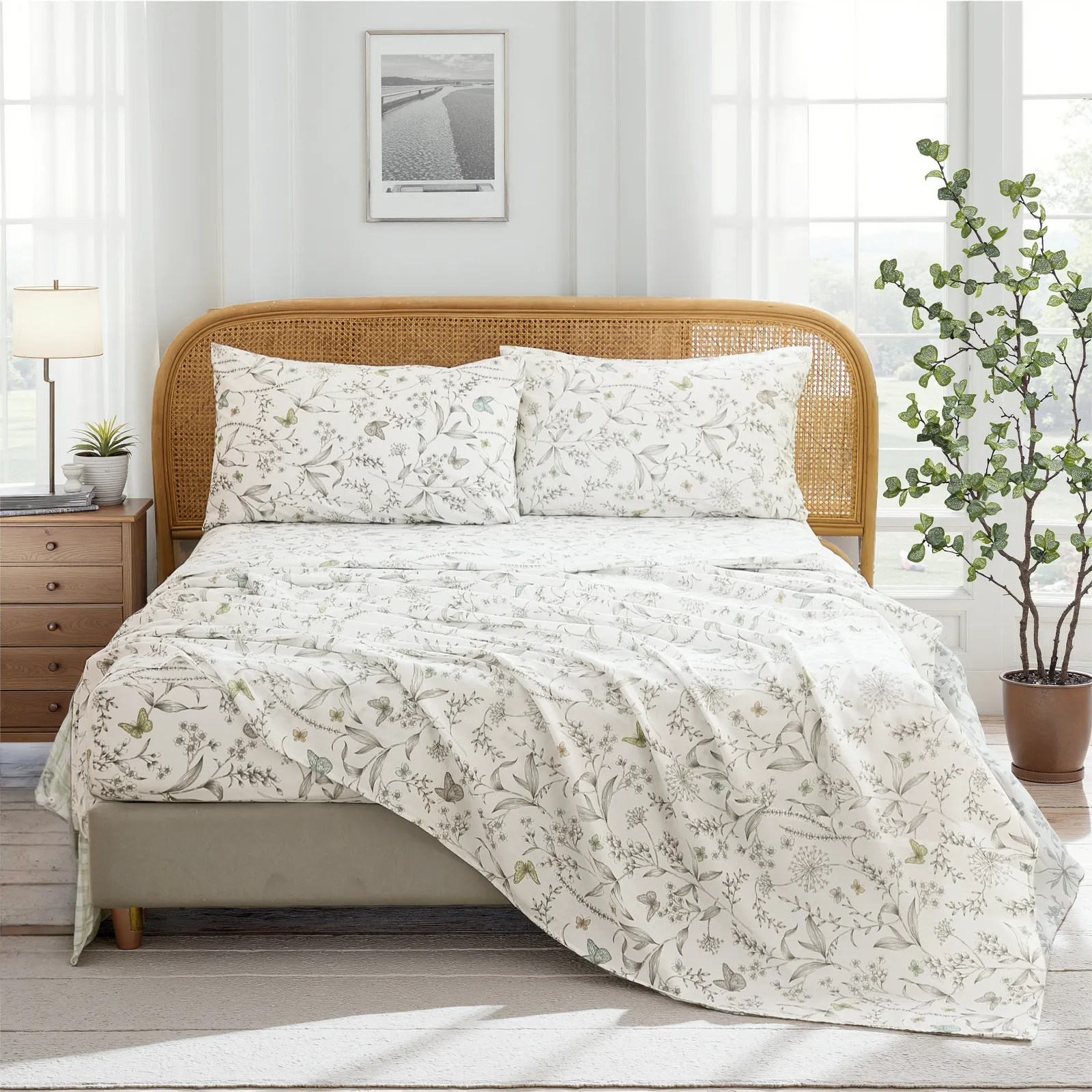 Full room view of cotton botanical sketch floral sheet set on bed with rattan headboard