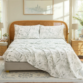 Full room view of cotton greenery sketch sheet set on bed with rustic rattan headboard