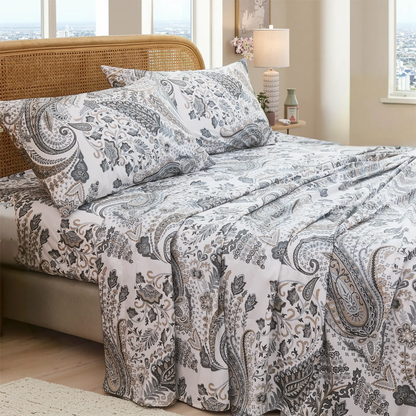 Full room view of cotton neutral paisley print sheet set on bed with rattan headboard