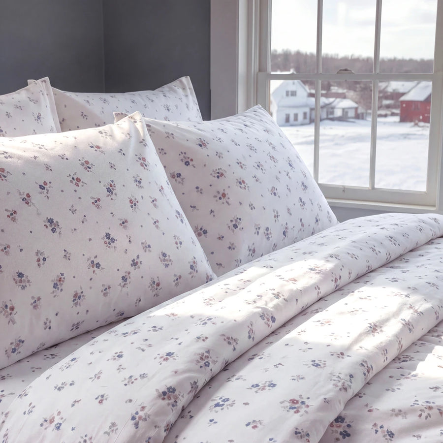 country breeze ditsy floral duvet cover set ivory blue rose pillow closeup snowy bedroom