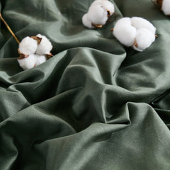 Dark green duvet cover with scattered cotton buds, top angle view