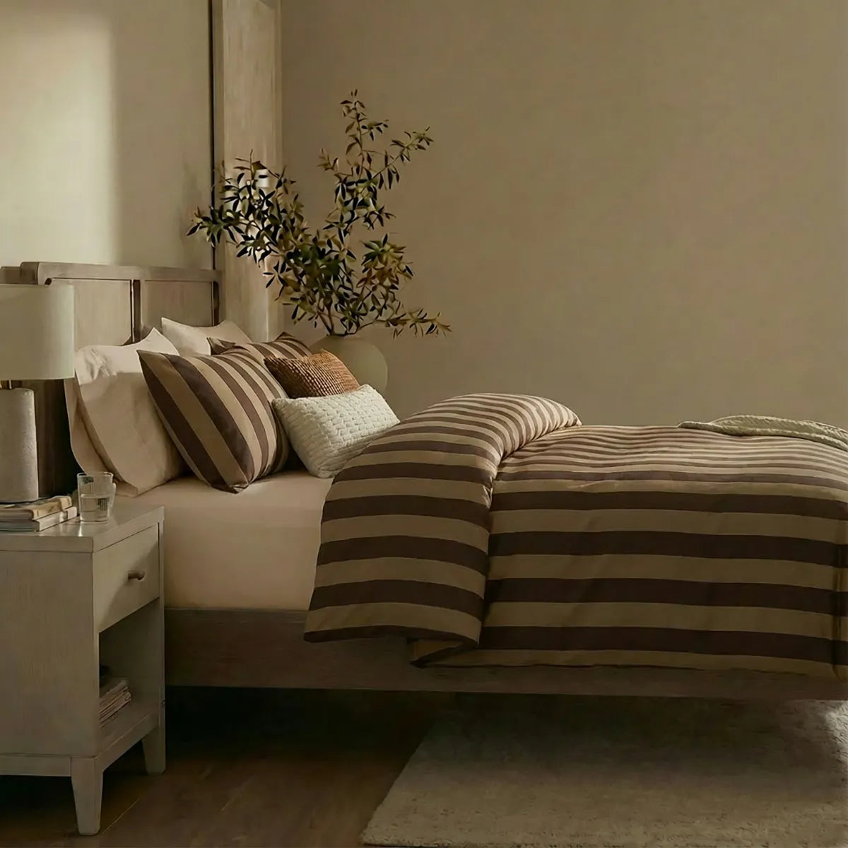 Side view of dark and light brown striped duvet and pillows
