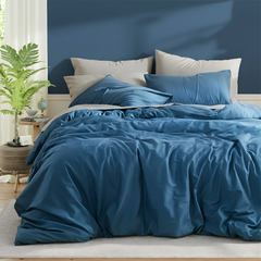 Side view of deep blue duvet with five pillows arrangement