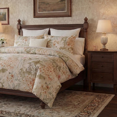 Angled shot of elegant floral bedspread and nightstand