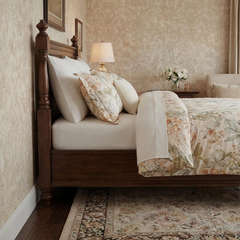 Side profile detail of floral pillows and wooden headboard