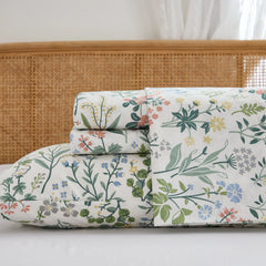 Detailed close-up of the neatly folded cotton floral sheet set stack