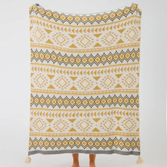 Full size boho geometric knit throw blanket with tassels in mustard yellow and cream studio shot
