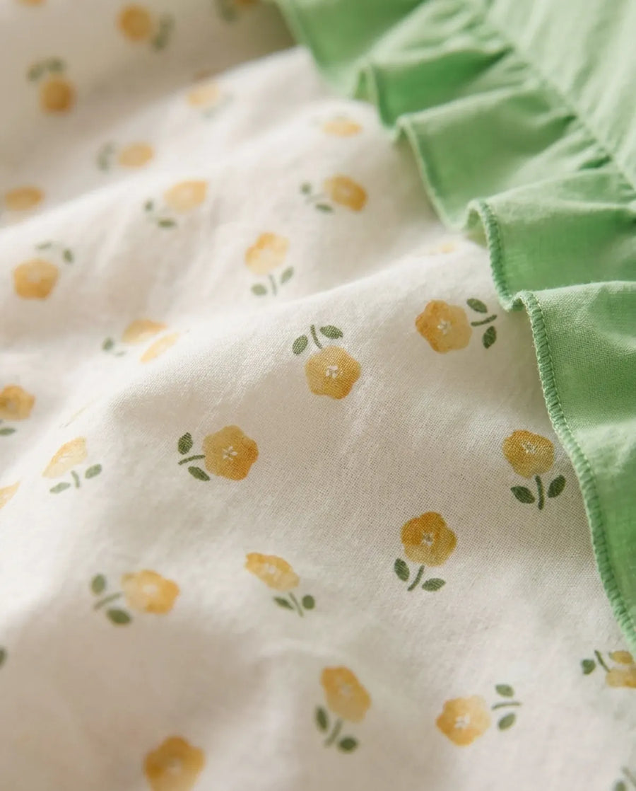 golden ditsy floral fabric close up yellow ditsy print detail