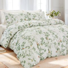Full view of the green leaf comforter set styled on a bed in a bright room.
