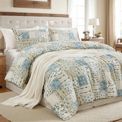 angled view of the green patchwork comforter set, showing the pillows and decorative items.