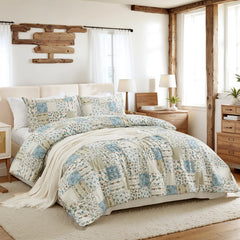 side view of the green patchwork comforter set on the bed, showing its thickness