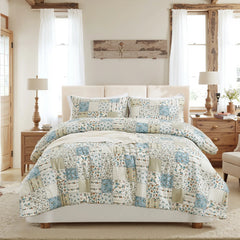 Full view of the green patchwork comforter set on a bed.