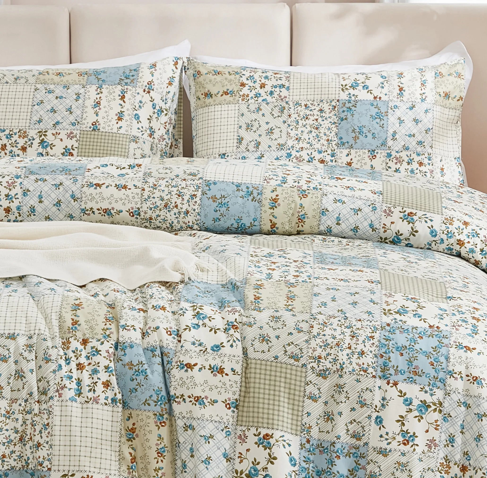 Detailed view of the fabric texture and stitching of the green patchwork comforter set
